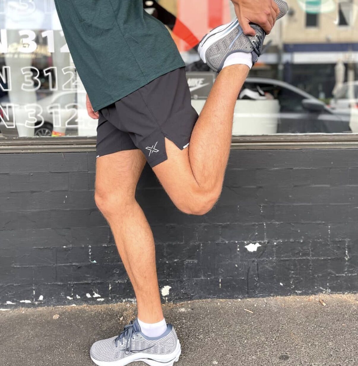 Man wearing the best running shorts while stretching