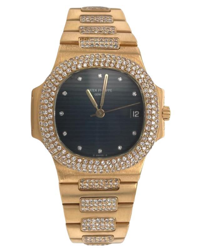 A diamond studded gold watch with a blue face