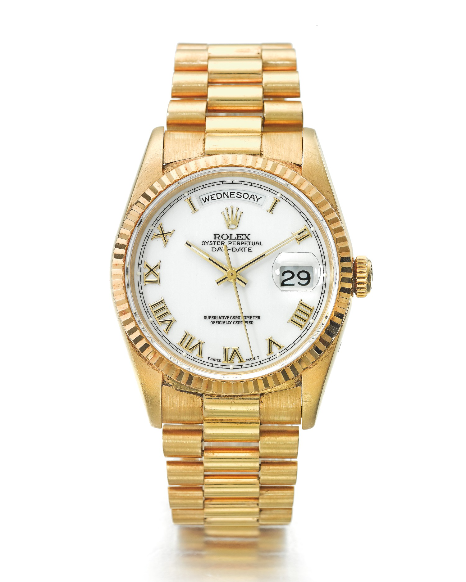 A gold watch with a white face