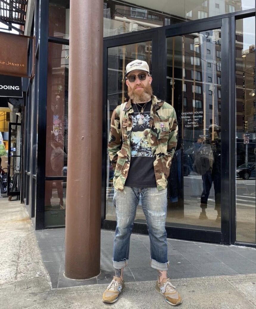 man standing in front of a store