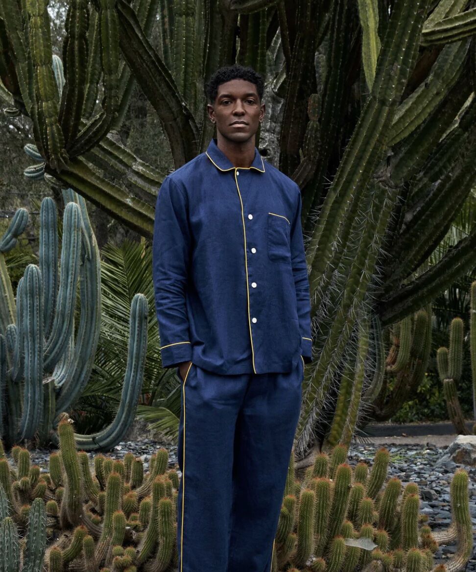 man standing in front of cactus in pajama set