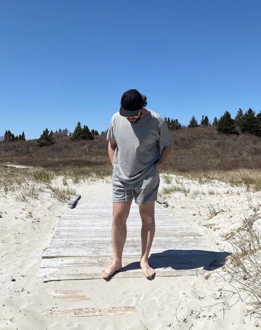 man on a beach boardwalk wearing a lounge set