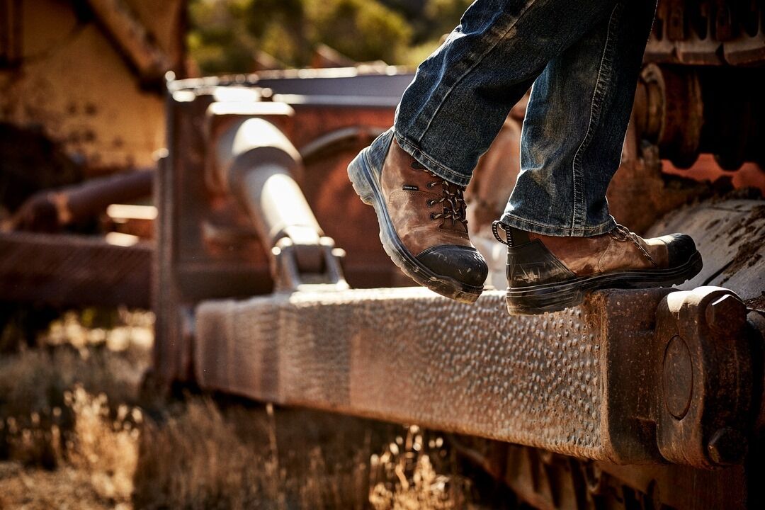 Close up photo of waterproof boots worn by a man