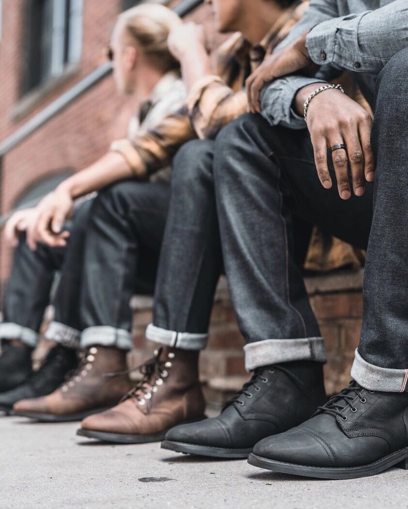 men sitting on stairs showing just their boots