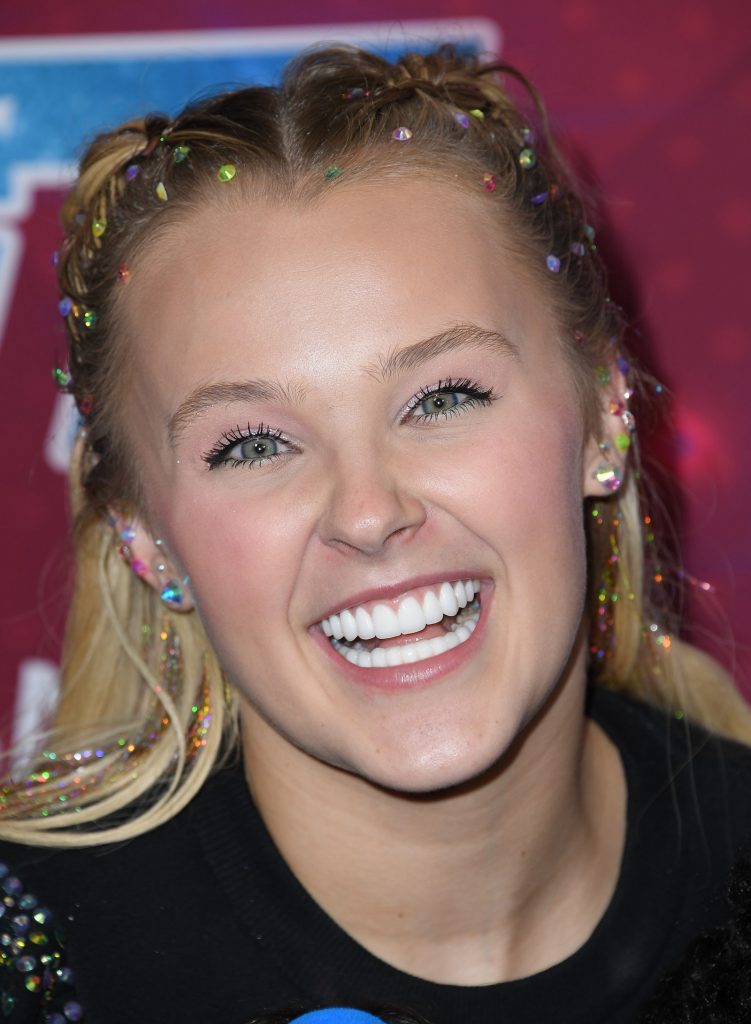 Jojo Siwa’s Hair Is a Rainbow Eruption Doused In Holographic Hair Tinsel and All-Over Gems