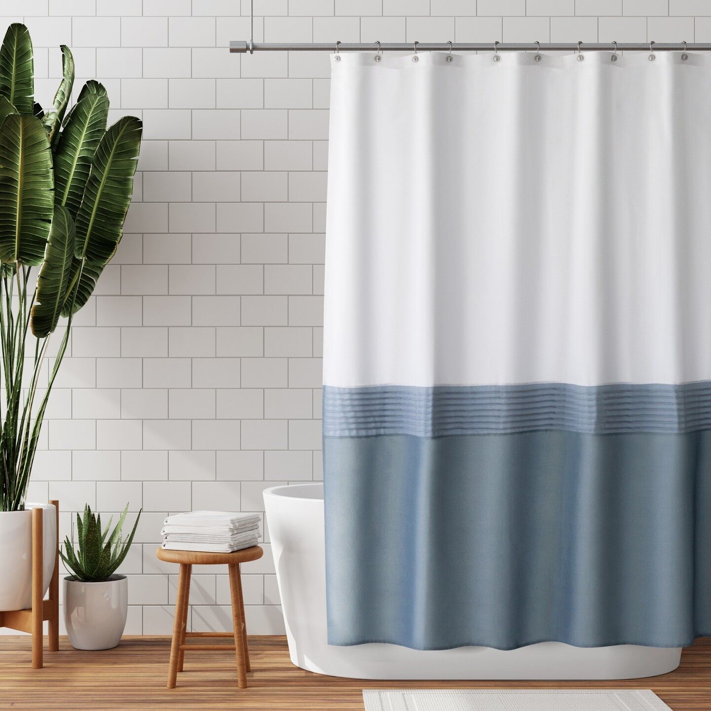 Bathroom with shower curtain and towels on stool