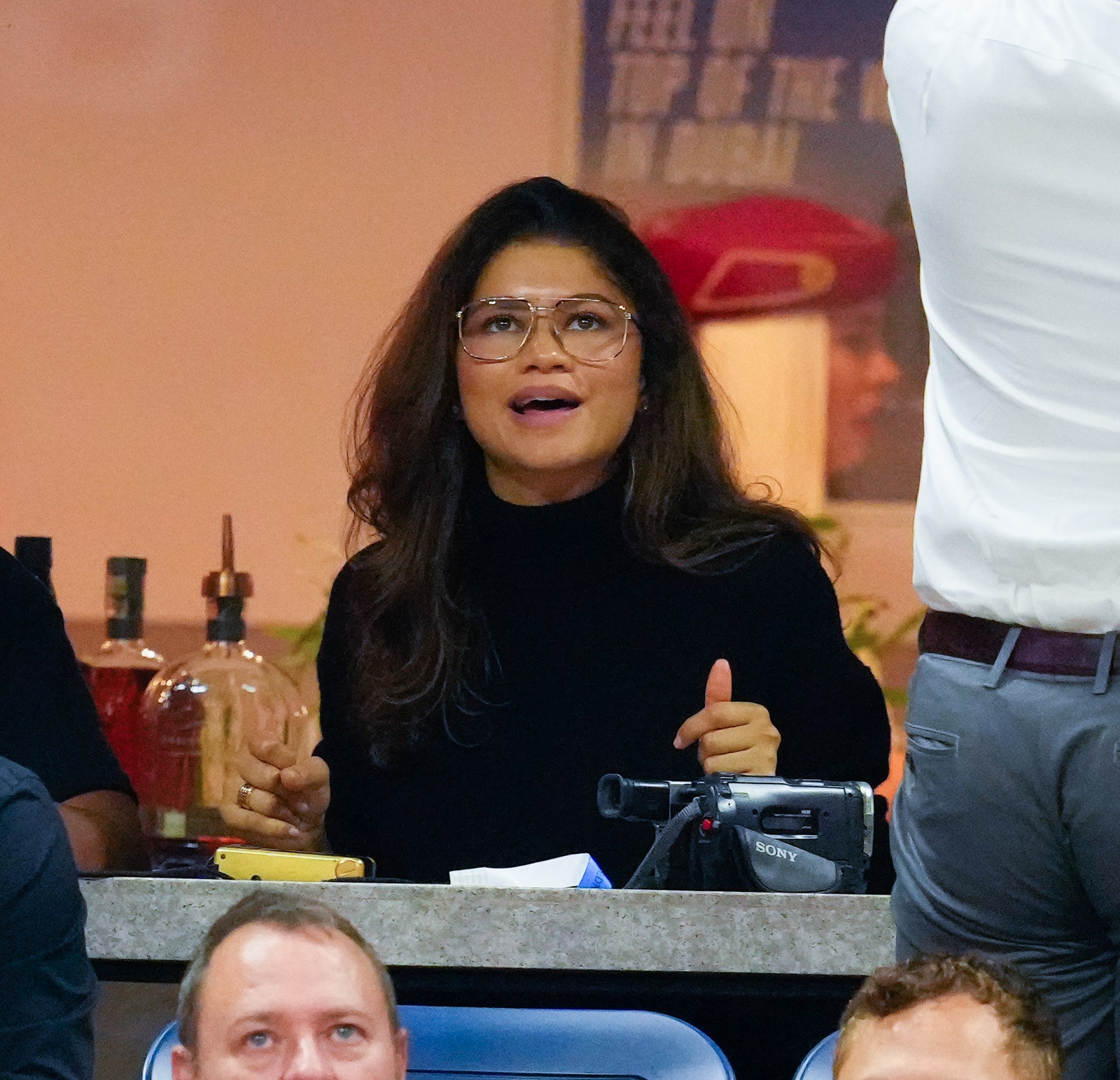 closeup of zendaya at 2022 us open with voluminous blowout and black turtleneck