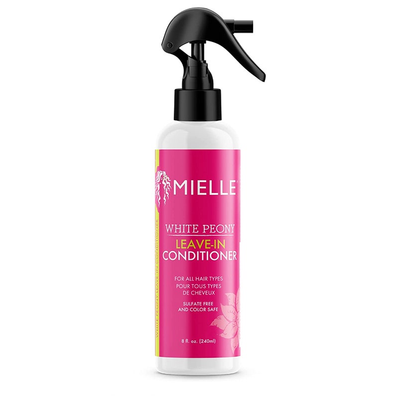 A pink bottle of the Mielle Organics White Peony Leave-In Conditioner on a white background