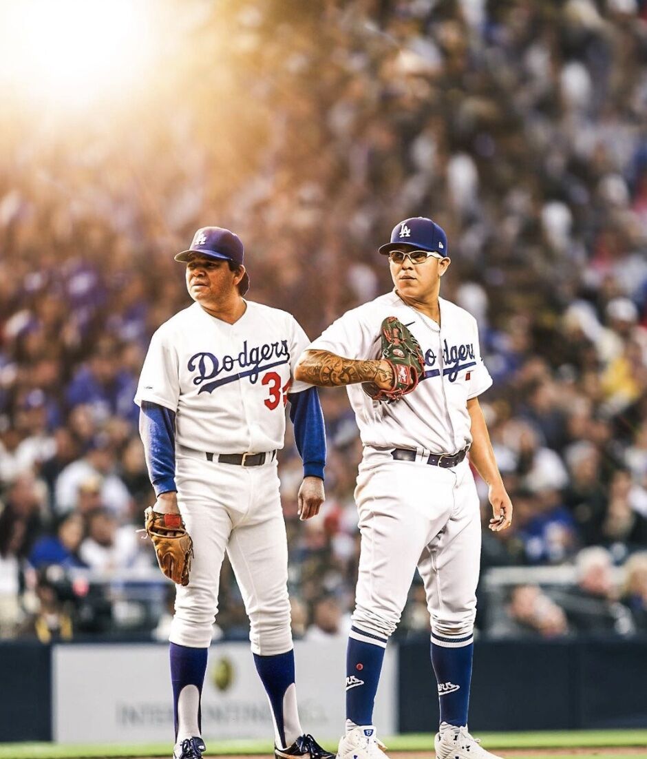 two dodger players standing on the baseball field