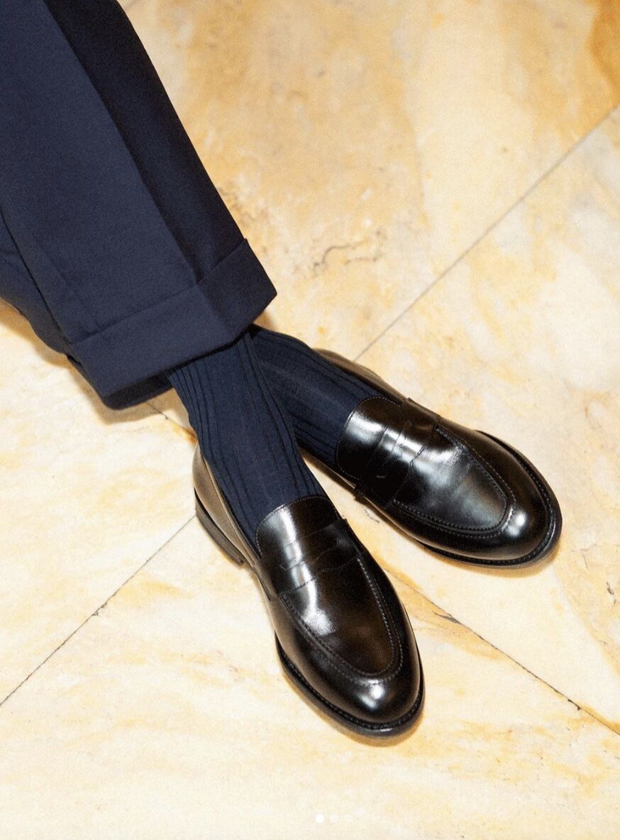 tailored navy pants, matching socks and black dress shoes